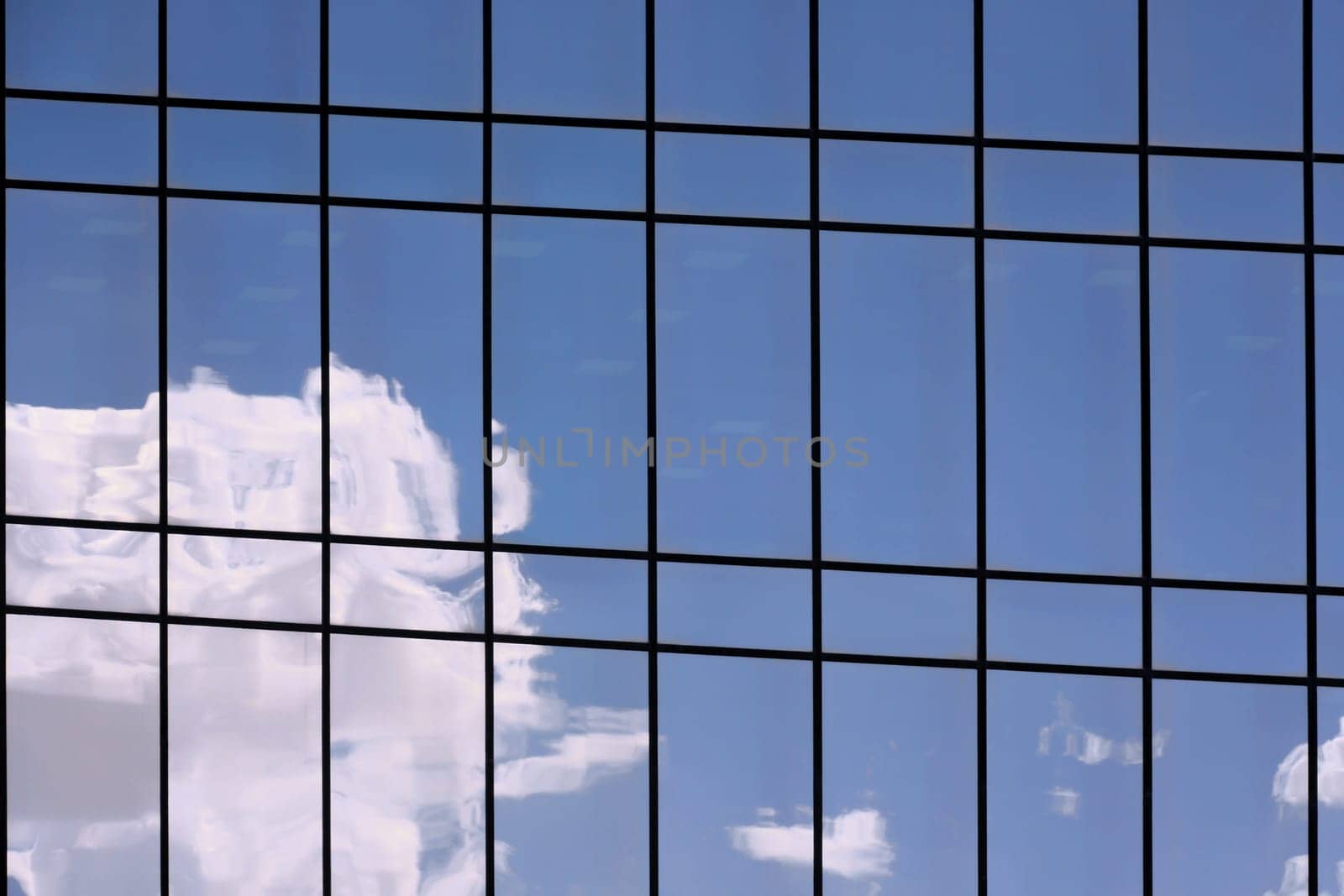 Reflections of clouds and sky on a shiny surface