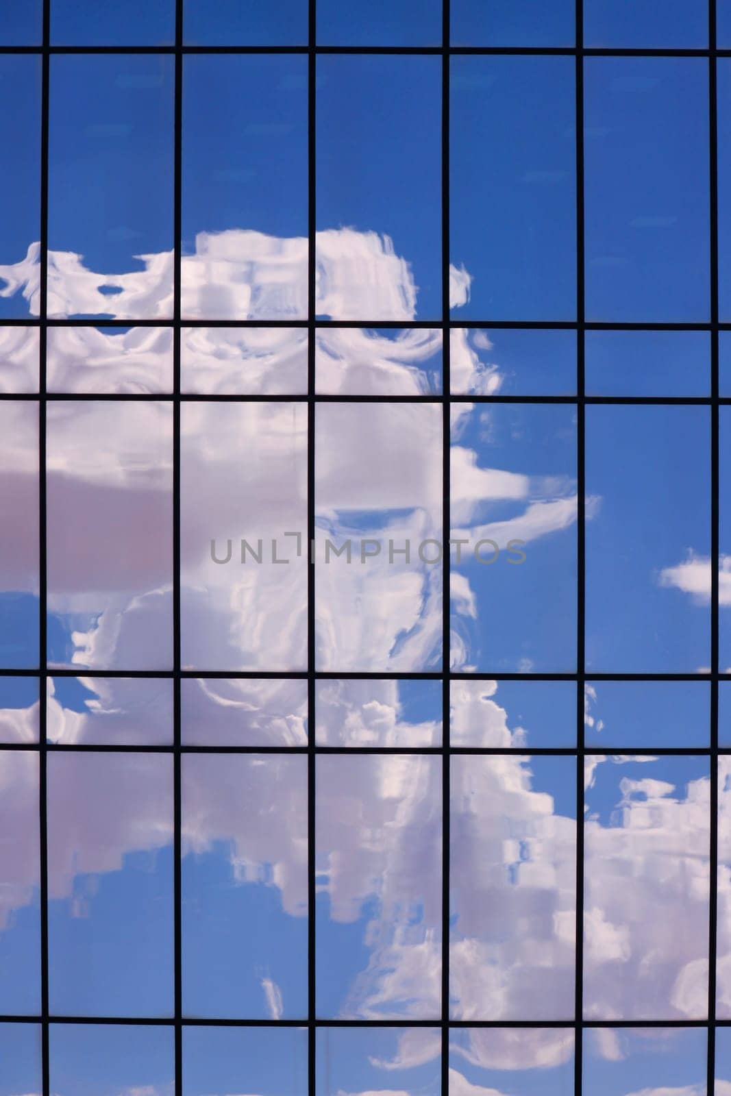 Reflections of clouds and sky on a shiny surface