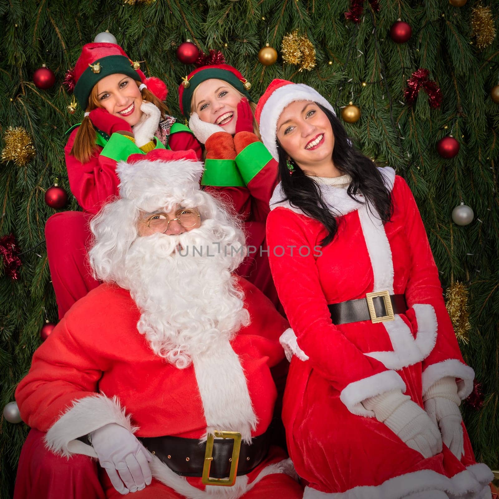 Santa Clause woman smiling elf helper sitting on Christmas armchair