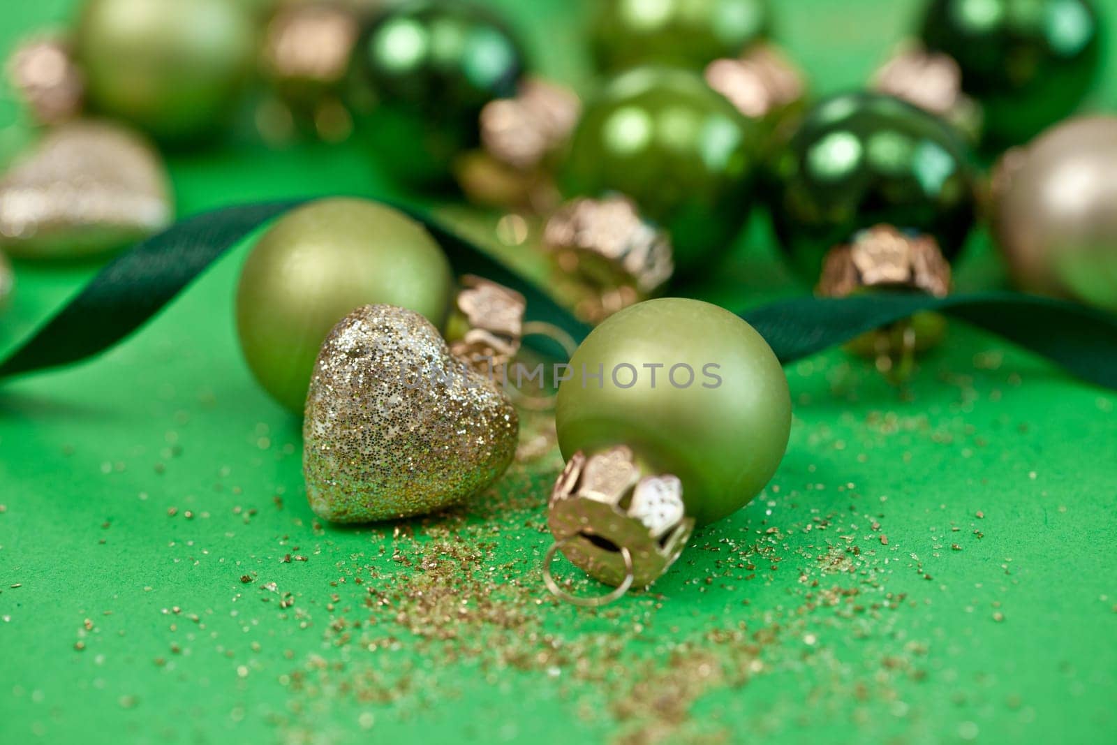 Christmas tree baubles in green tones and glittering hearts for Christmas