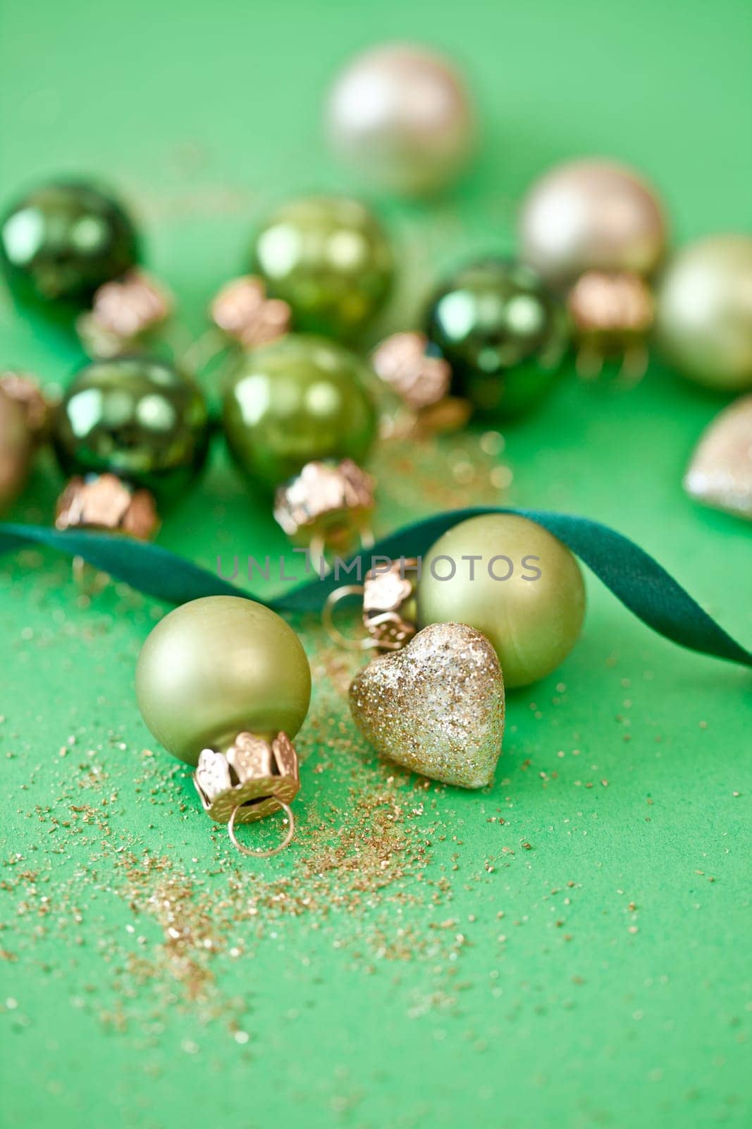 Christmas tree baubles in green tones and glittering hearts for Christmas