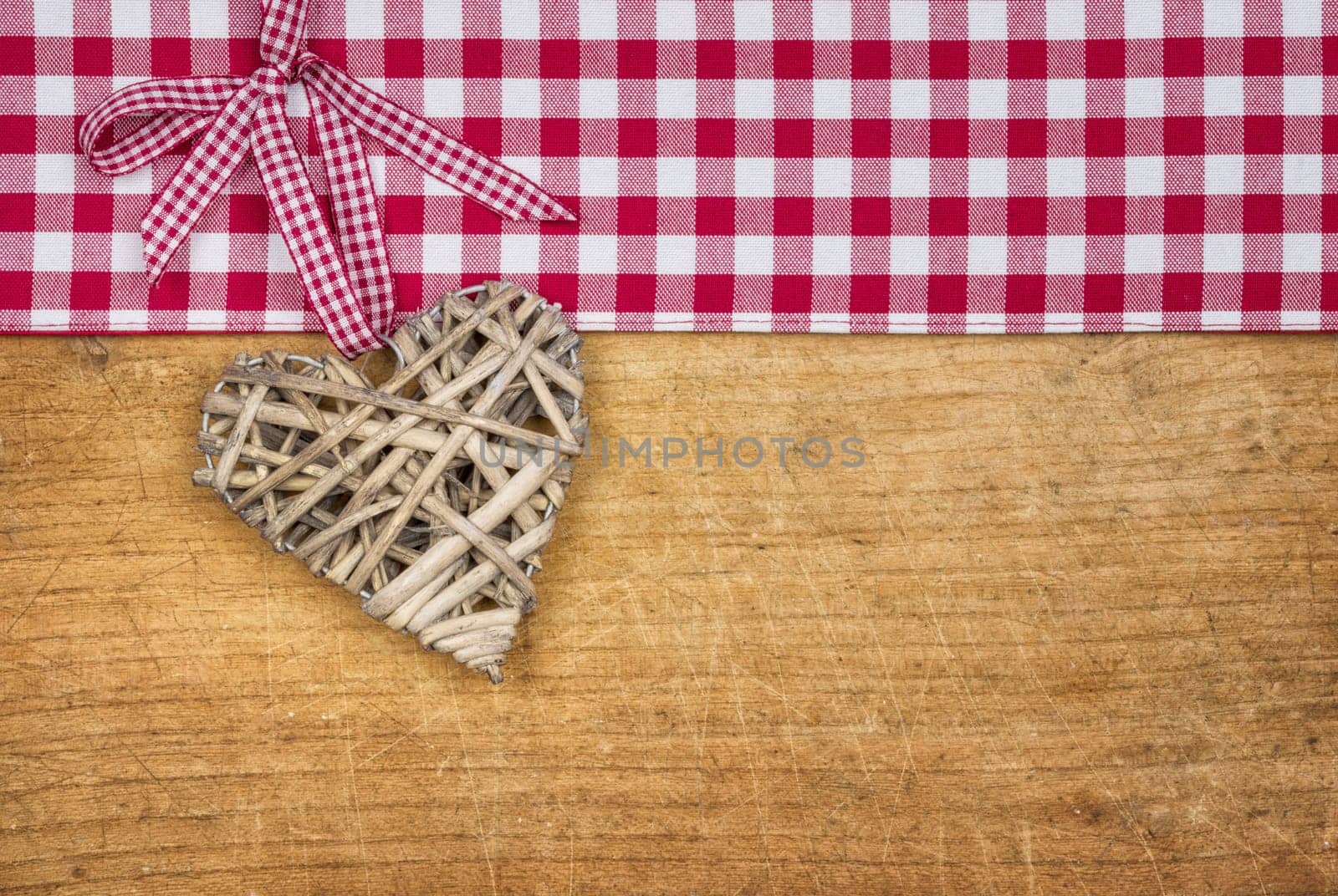 Rustic wooden background with a braided heart