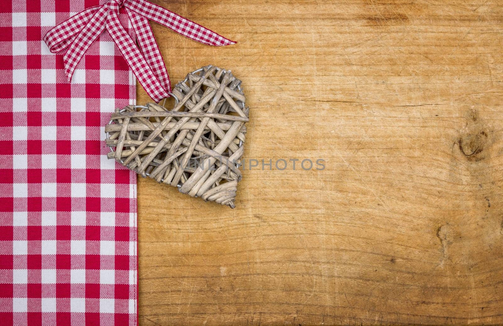 Rustic wooden background with a braided heart