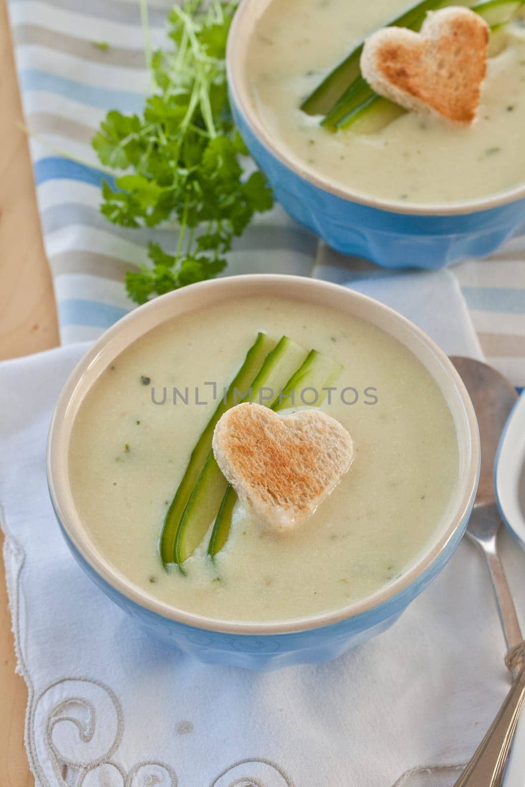 Creamy vegetable soup with cucumber and toasted white bread