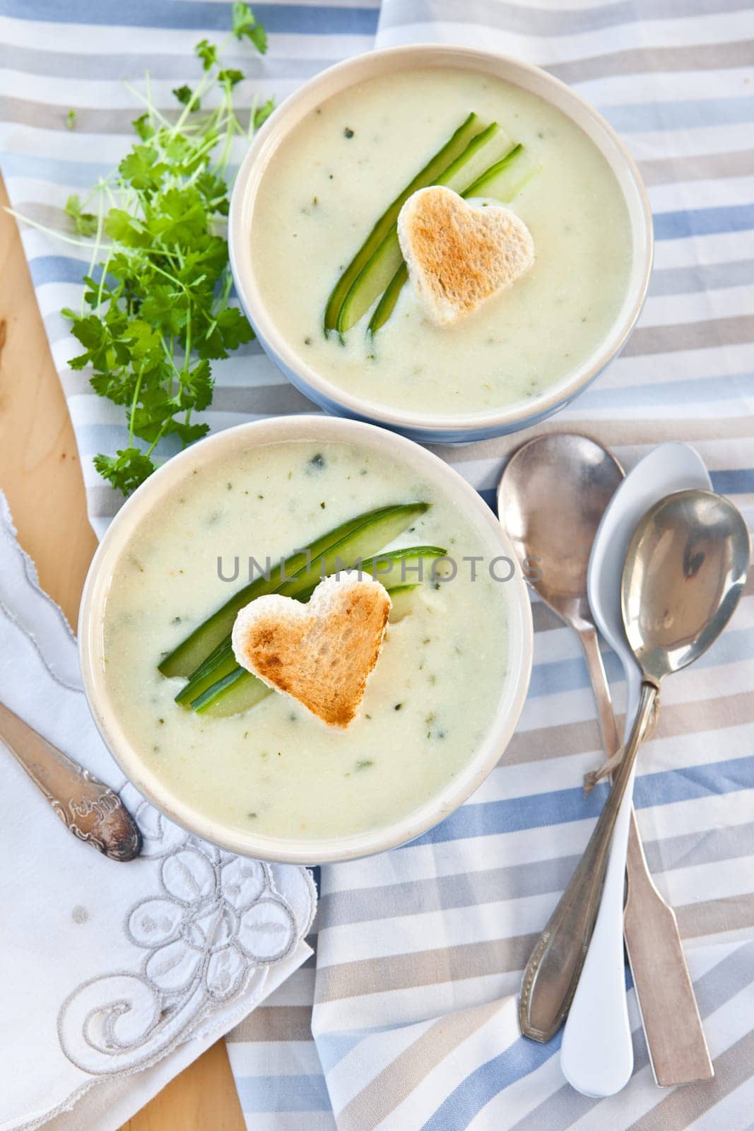 Creamy vegetable soup with cucumber and toasted white bread
