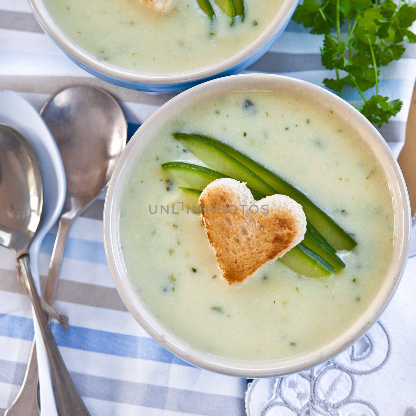 Creamy vegetable soup with cucumber and toasted white bread