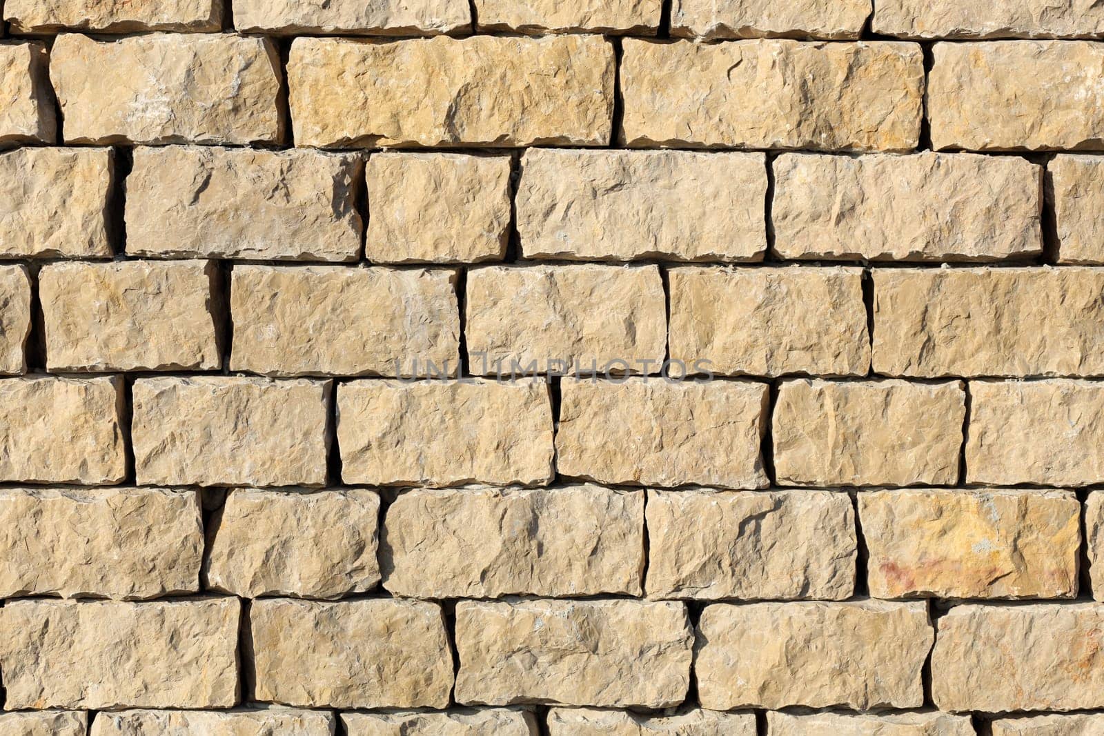 Detail of a outdoors wall made with stone stacked.