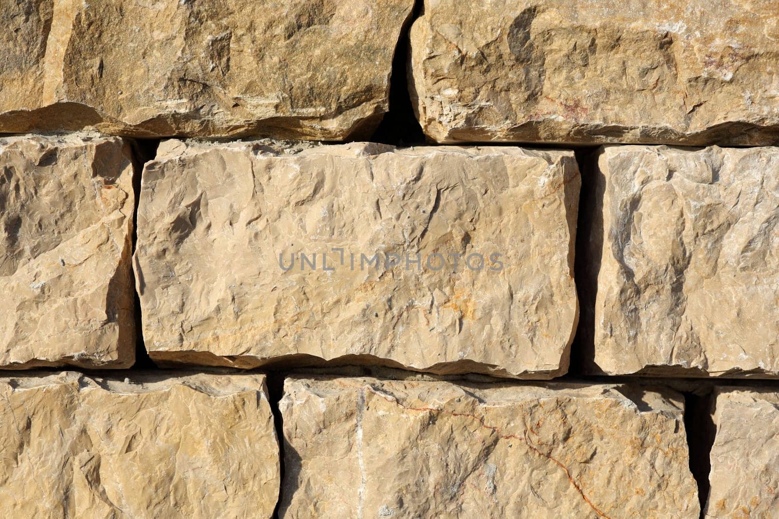 Detail of a outdoors wall made with stone stacked.