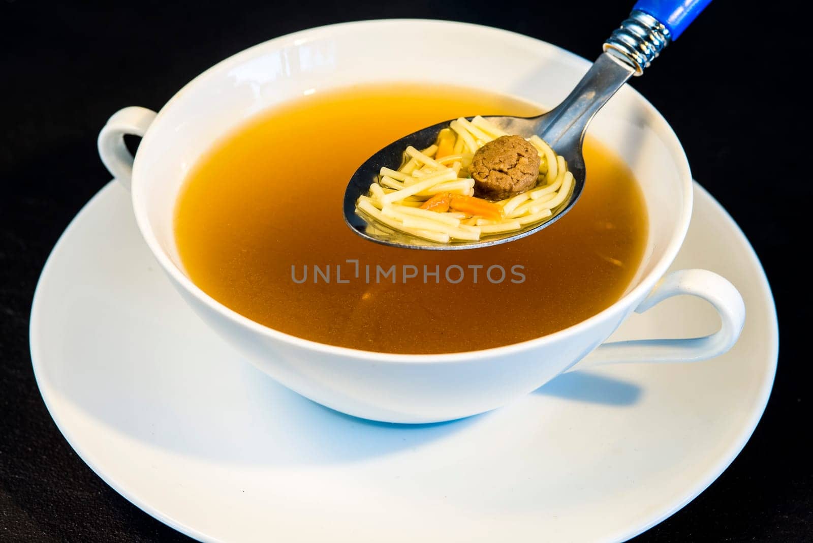 Beef broth with pasta and meatballs