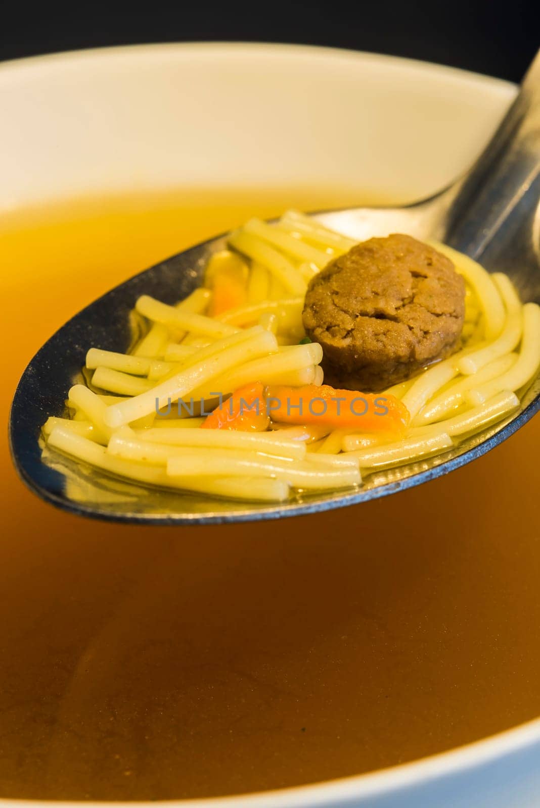 Beef broth with pasta and meatballs