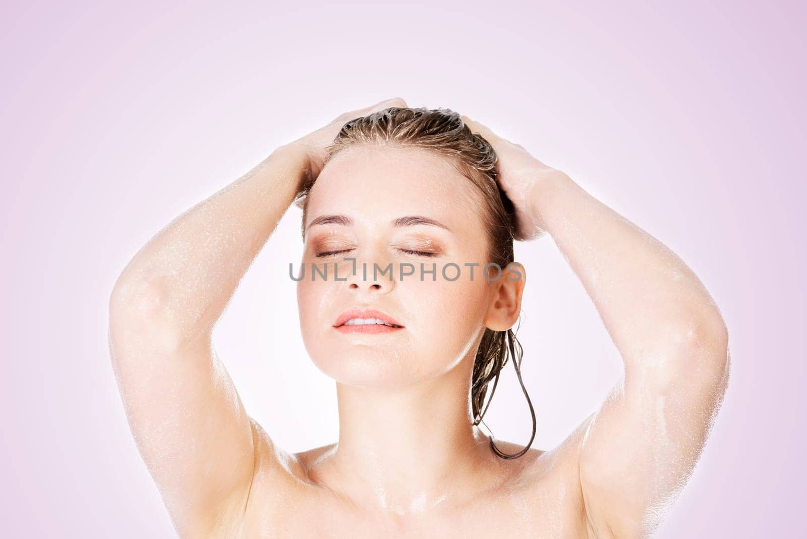 young fit woman in shower washing her body