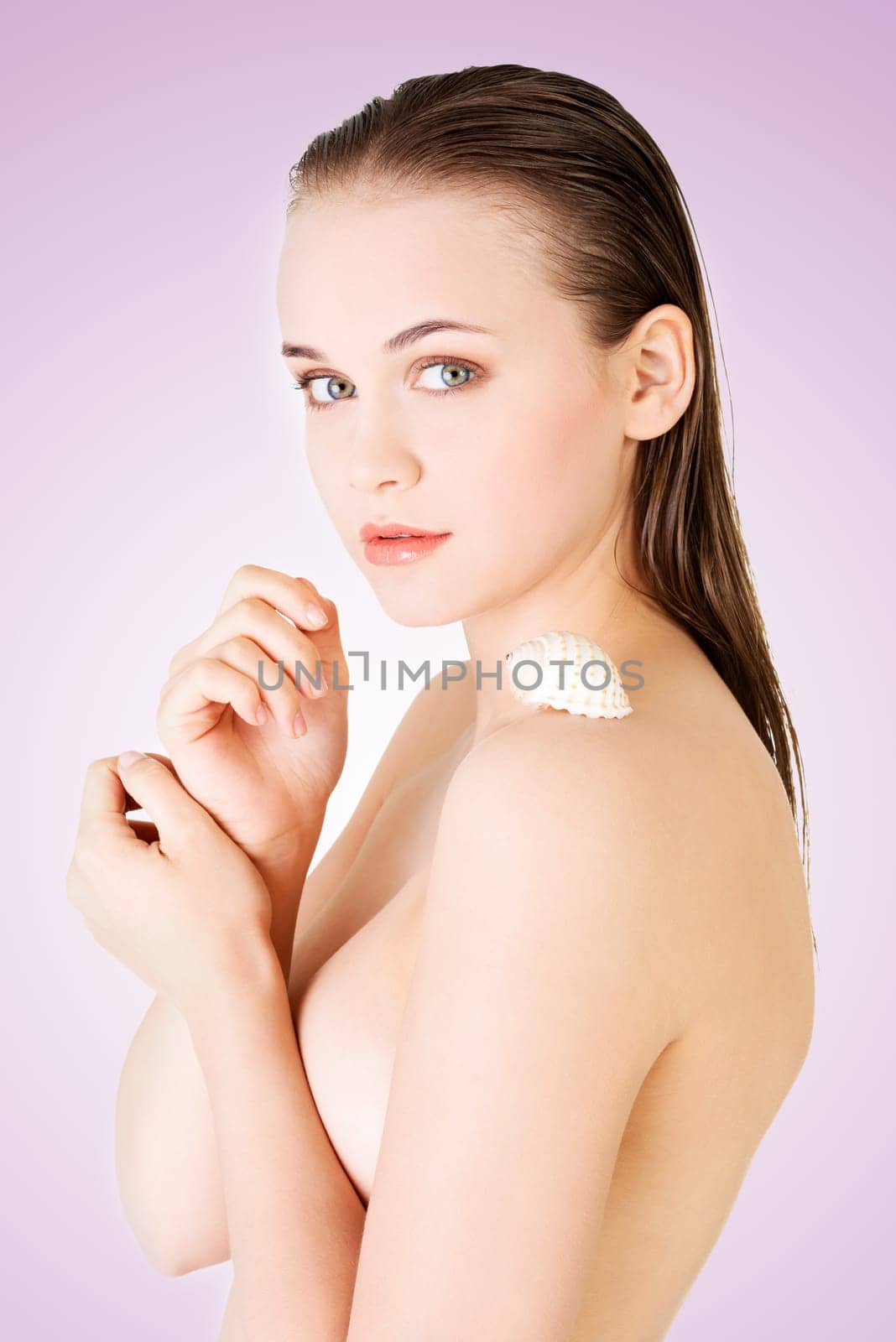 beautiful face of spa woman with clean skin and sea shell.