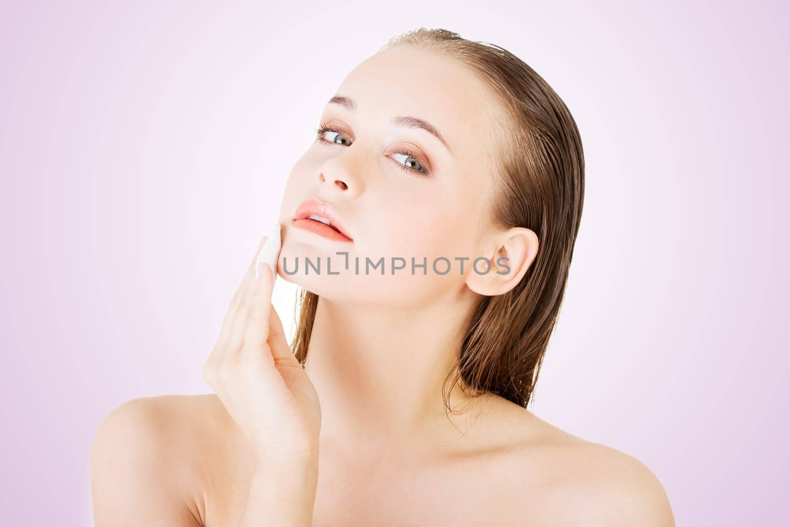 beautiful woman using cotton pad