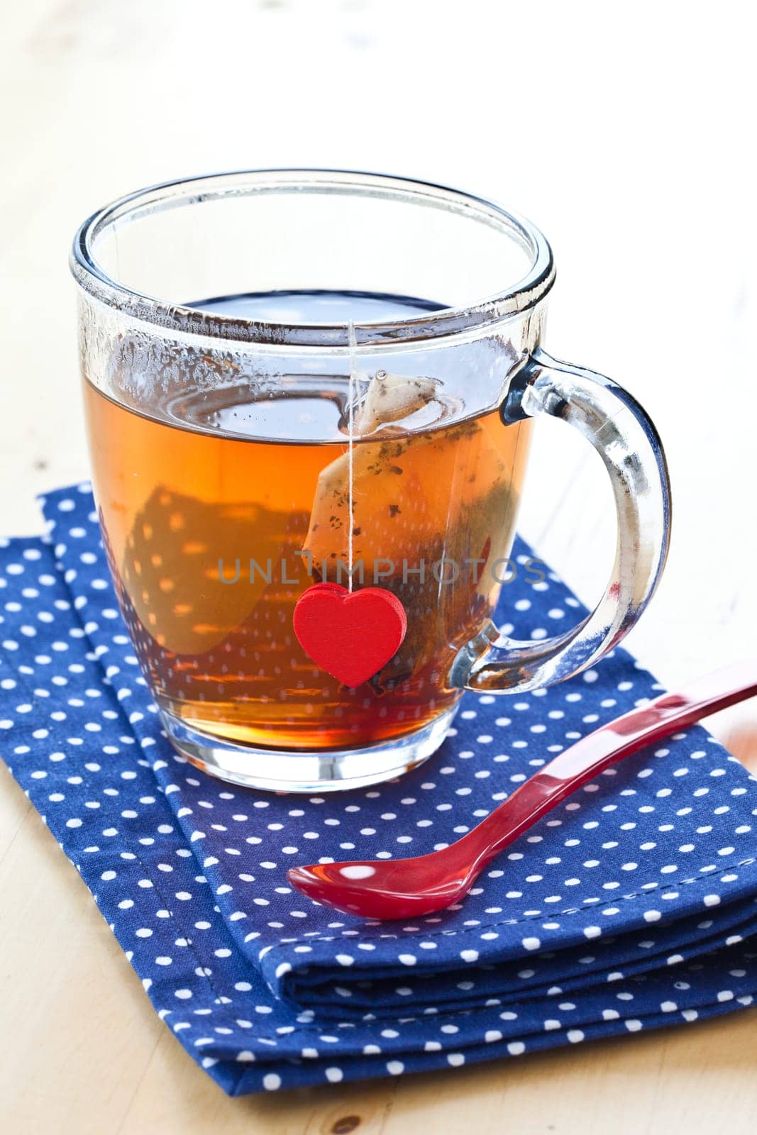 A cup of hot tea with a red heart