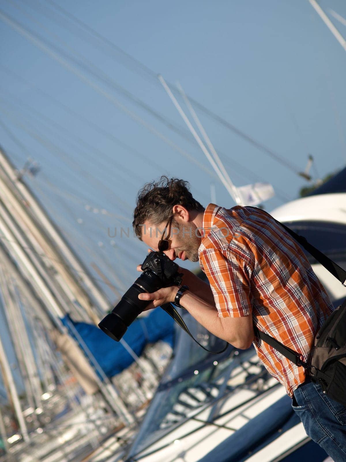 Handsome photographer at work in a harbour