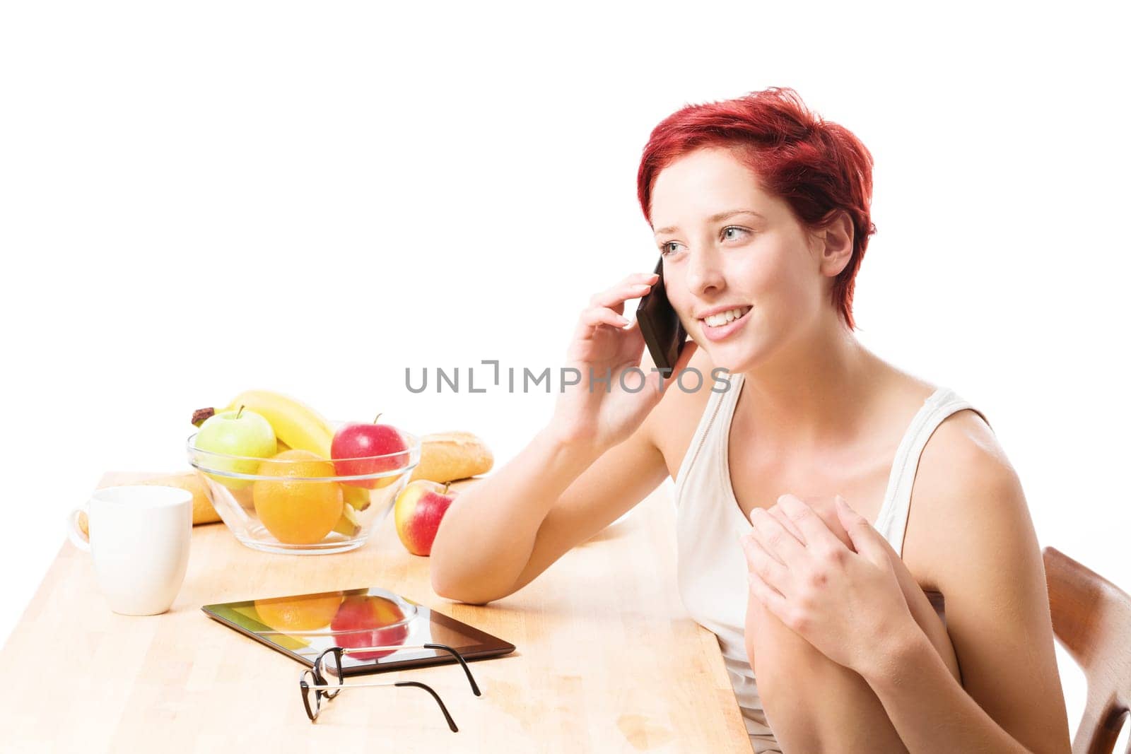 Young woman talking on the phone at breakfast