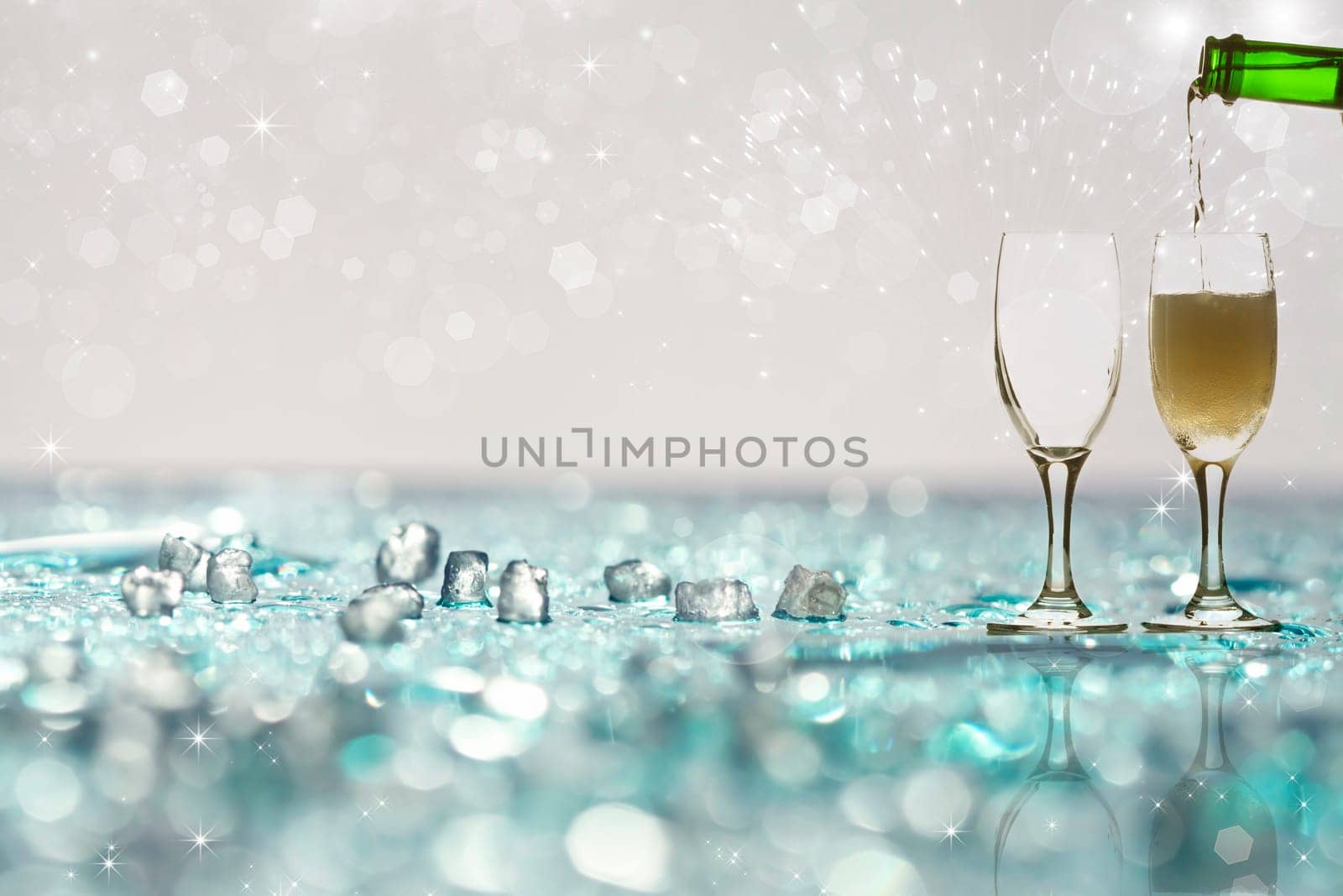 Pouring champagne against festive holiday lights