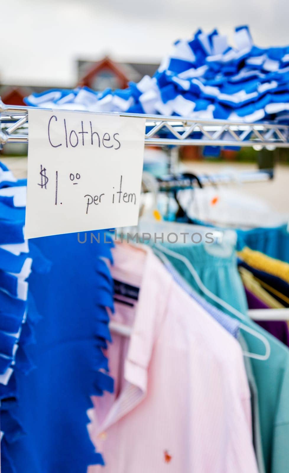 Closeup image of clothes and price tag at a garage sale