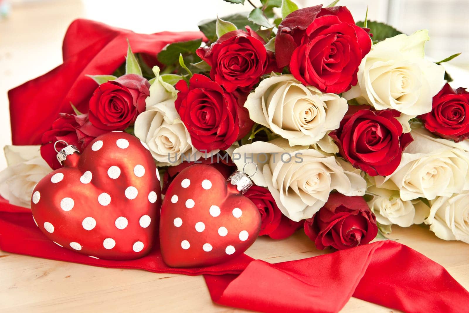 White and red roses with two red hearts