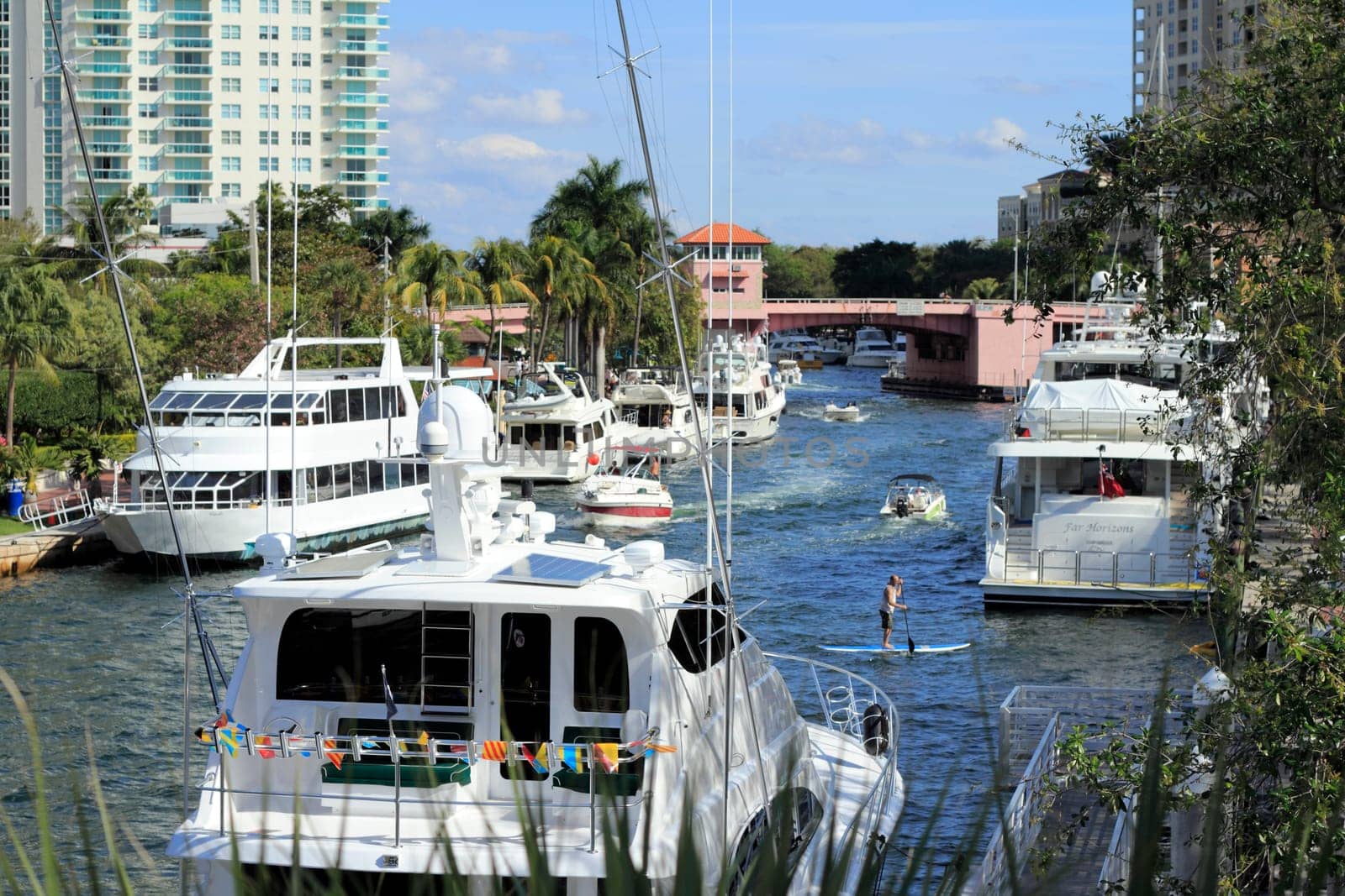 FORT LAUDERDALE, FLORIDA - FEBRUARY 3: Many boats, people and a paddle boarder enjoying winter recreation in the Riverwalk public park area of downtown February 3, 2013 in Ft Lauderdale, Florida.