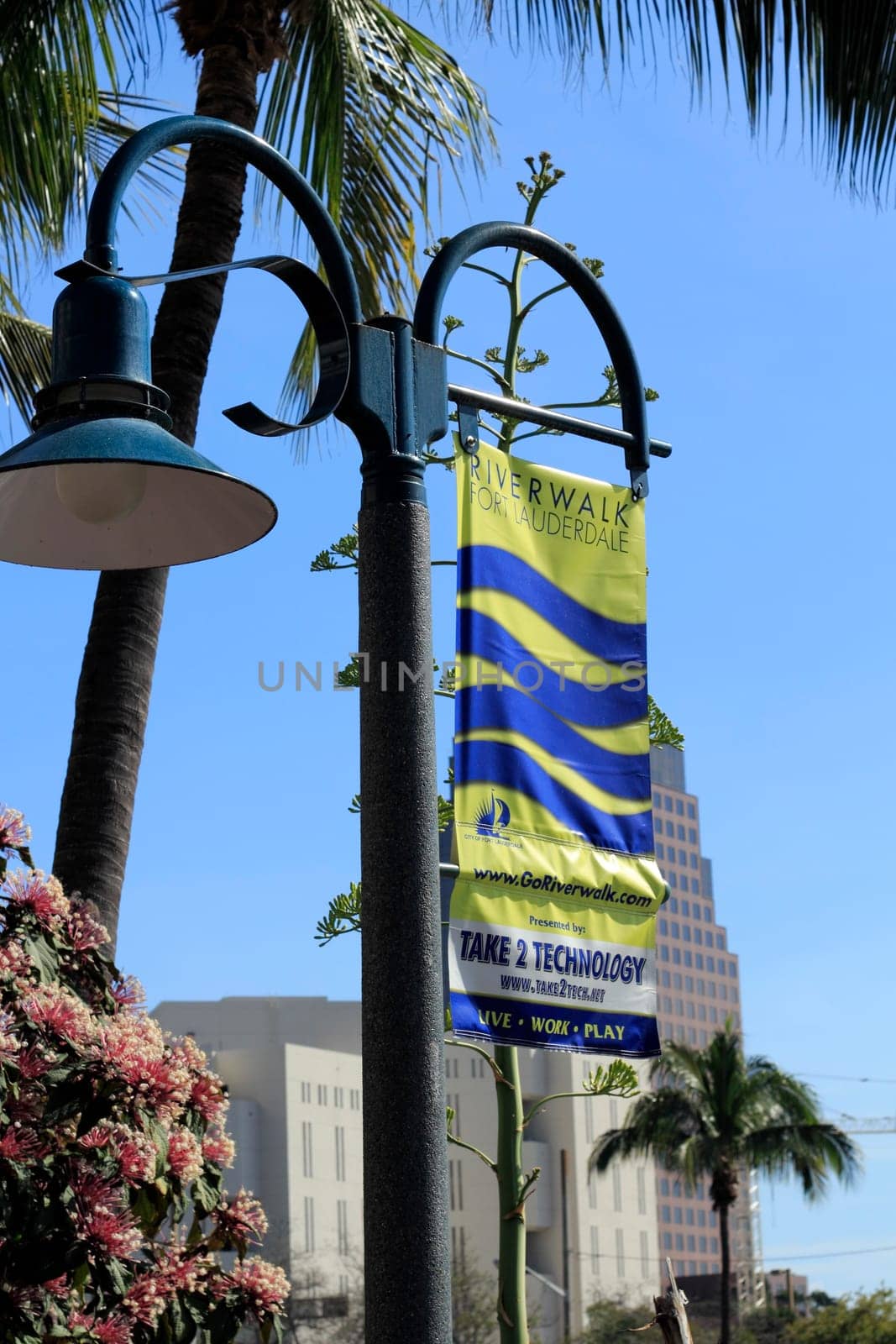 FORT LAUDERDALE, FLORIDA - FEBRUARY 3: Yellow and blue hanging banner showing the goriverwalk.com website and current events with live work play buzzwords February 3, 2013 in Ft Lauderdale, Florida.