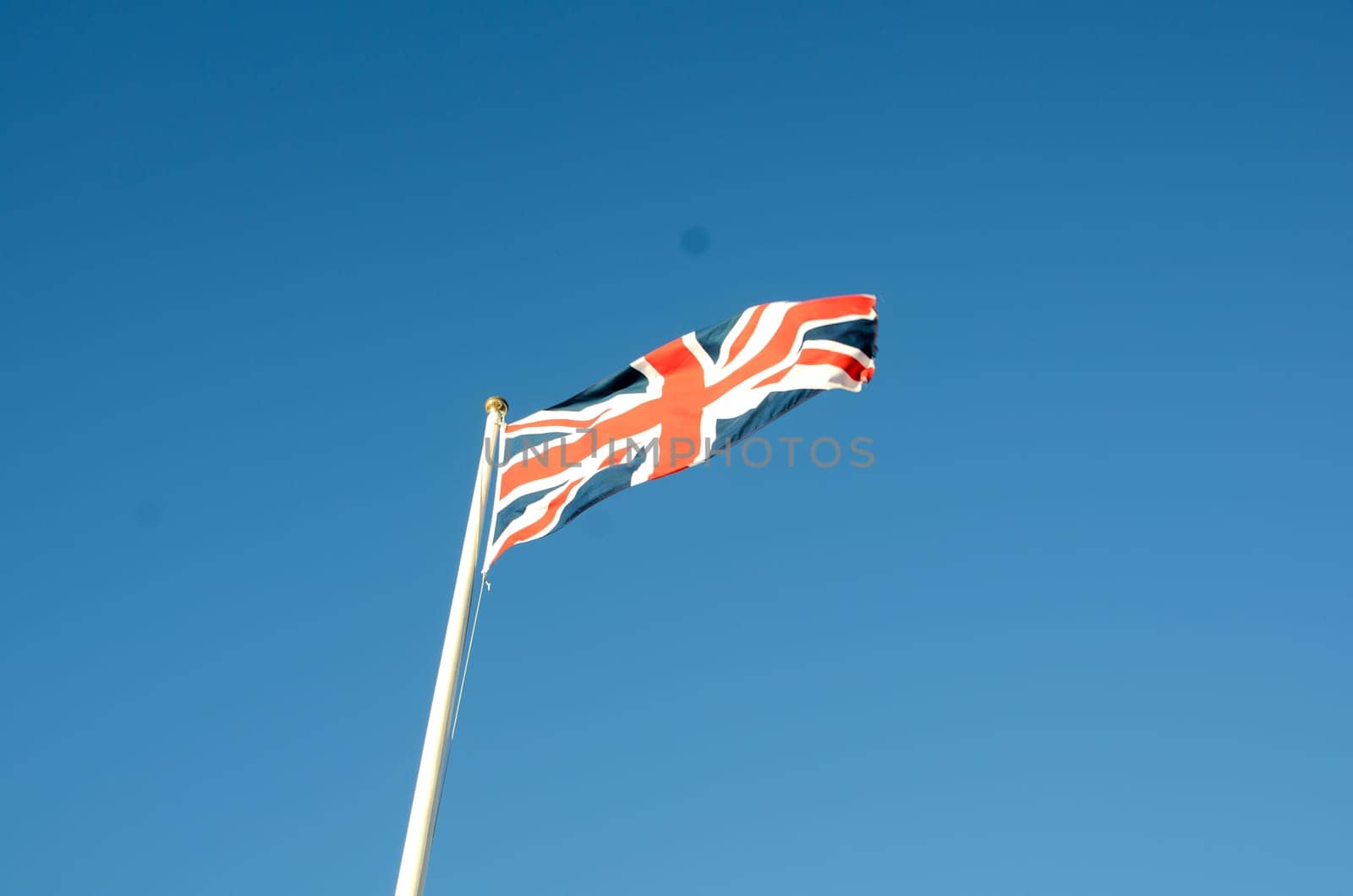 English flag in sunny autumn day against a blue sky