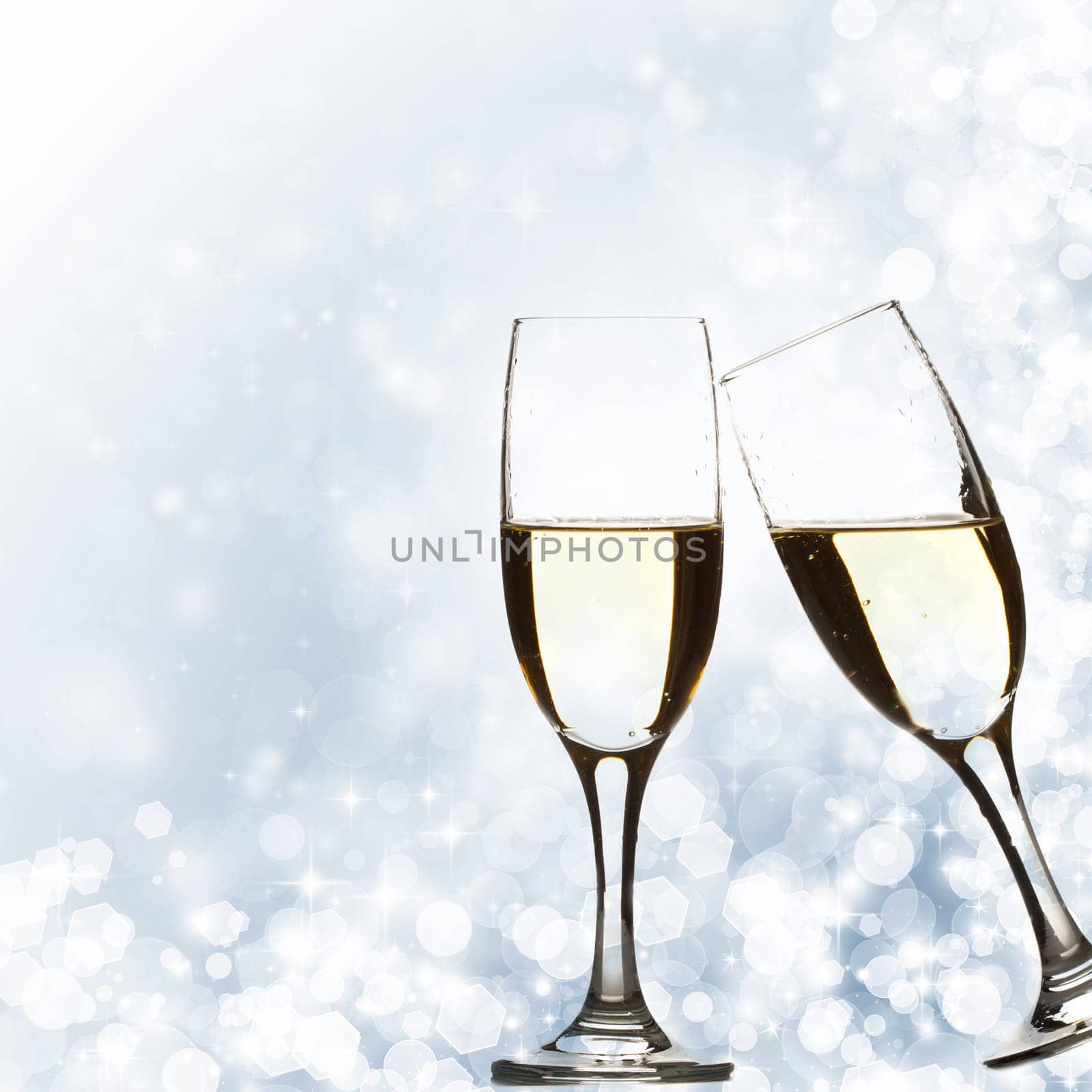 Glasses with champagne against fireworks