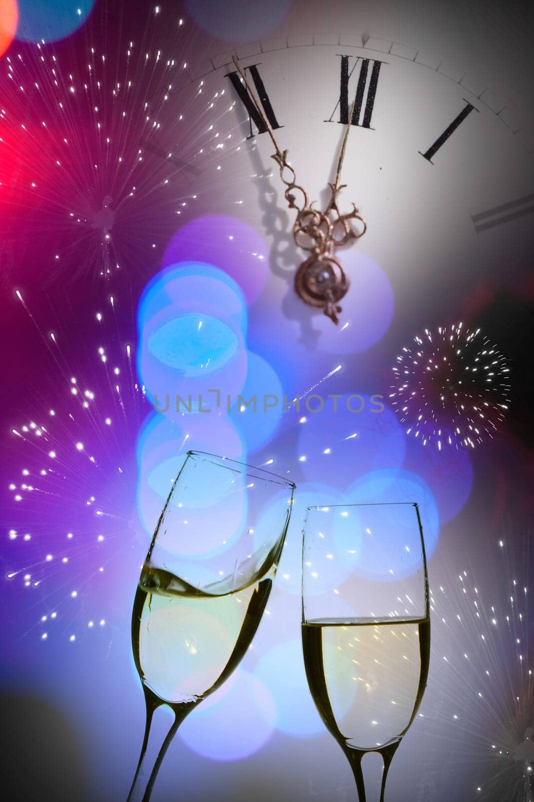 Glasses with champagne against fireworks and clock close to midnight