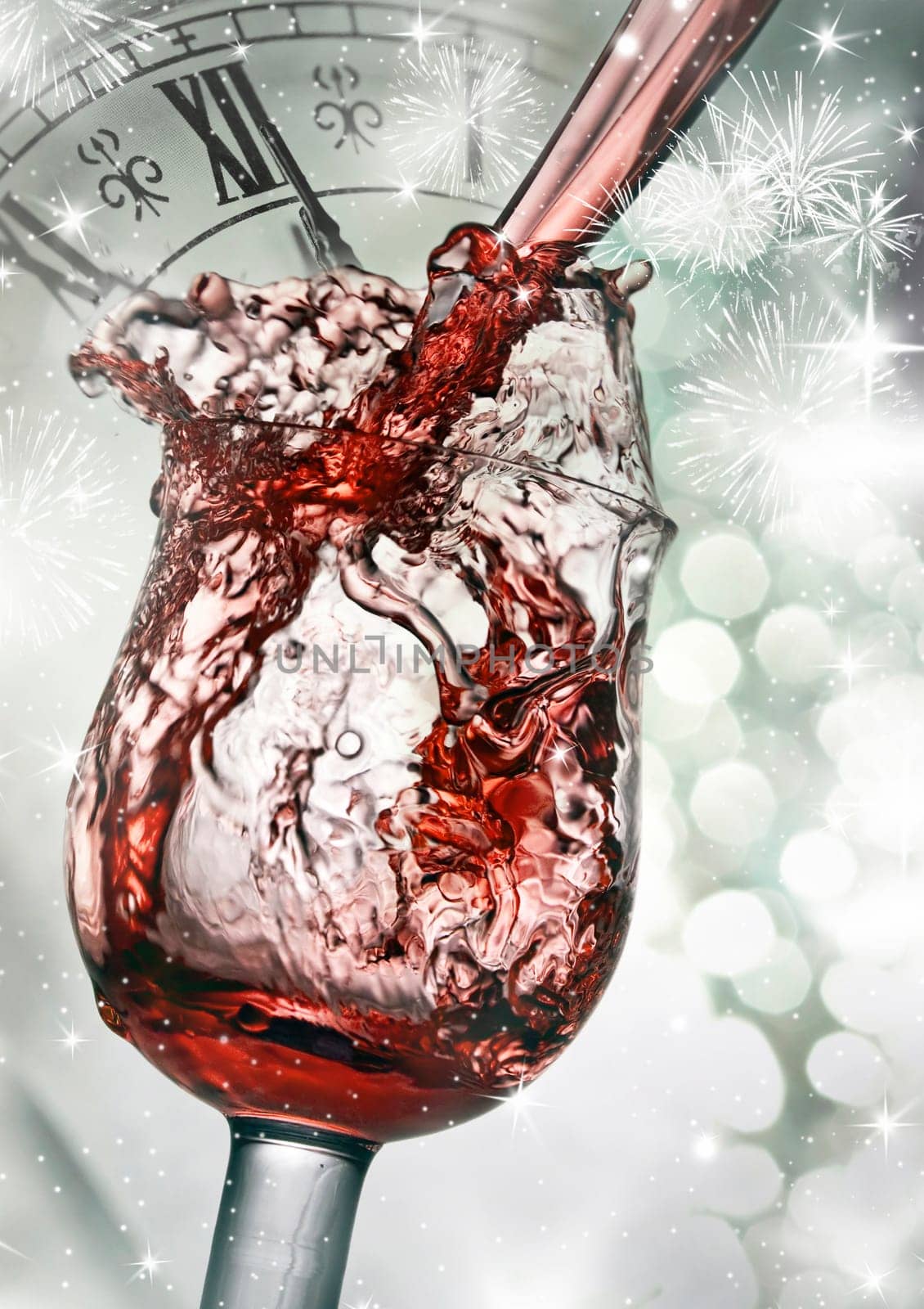 Red wine against silvery fireworks and holiday lights