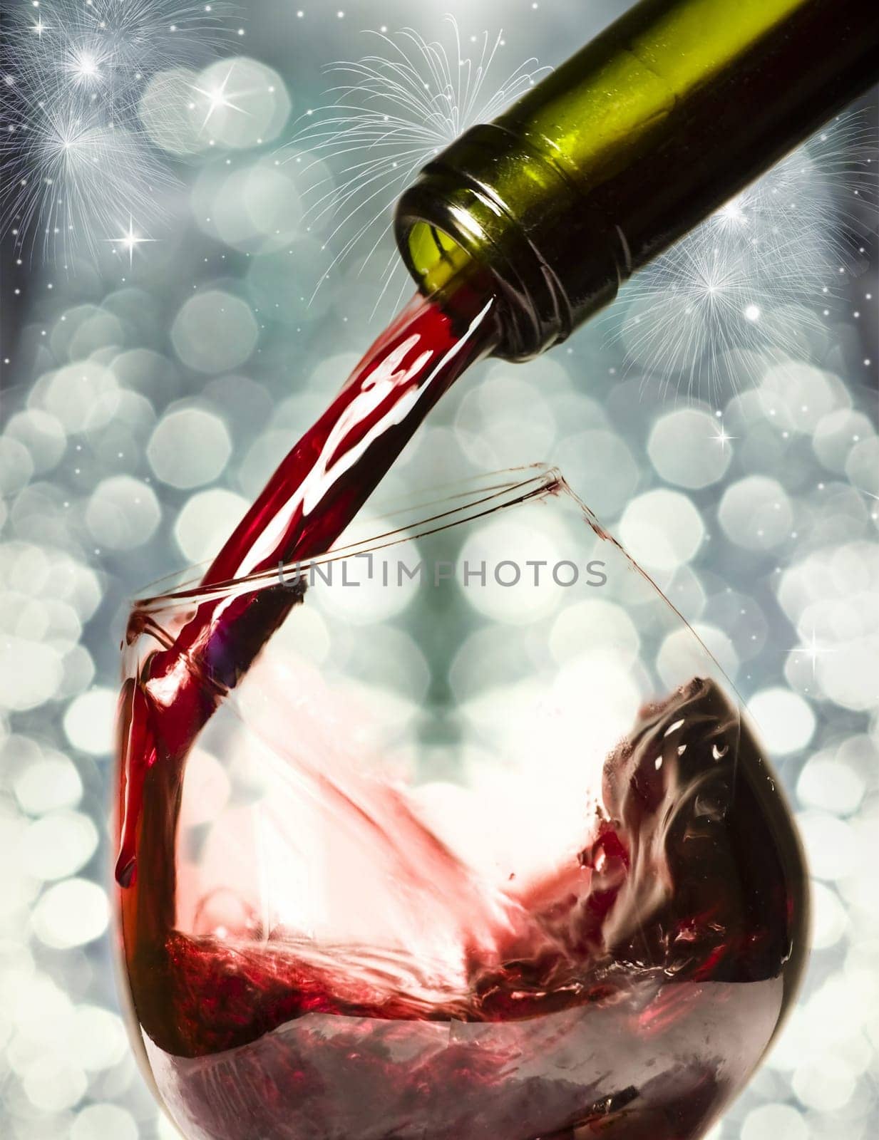 Red wine against fireworks and holiday lights