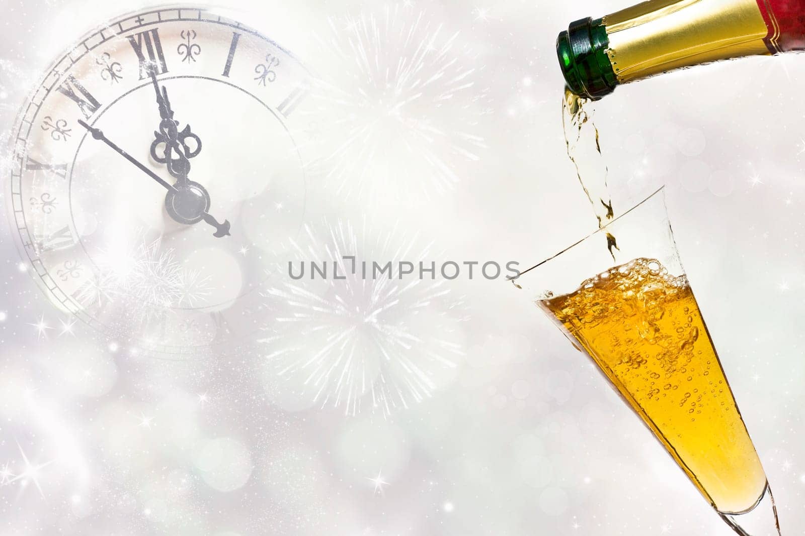 Glasses with champagne against fireworks and clock close to midnight