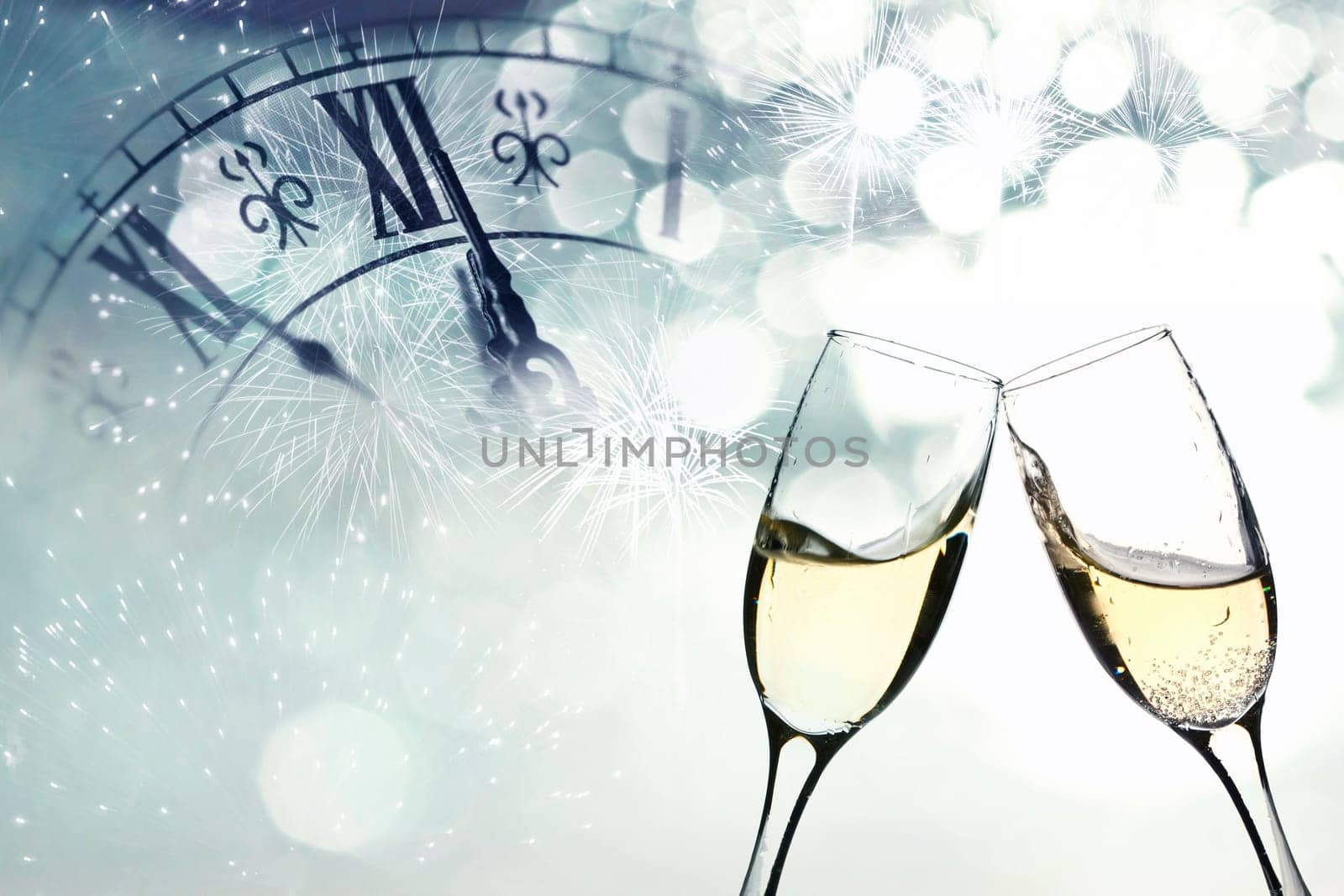 Glasses with champagne against fireworks and clock close to midnight