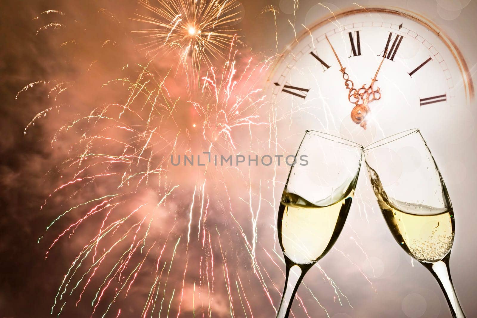 Glasses with champagne against holiday lights and clock close to midnight