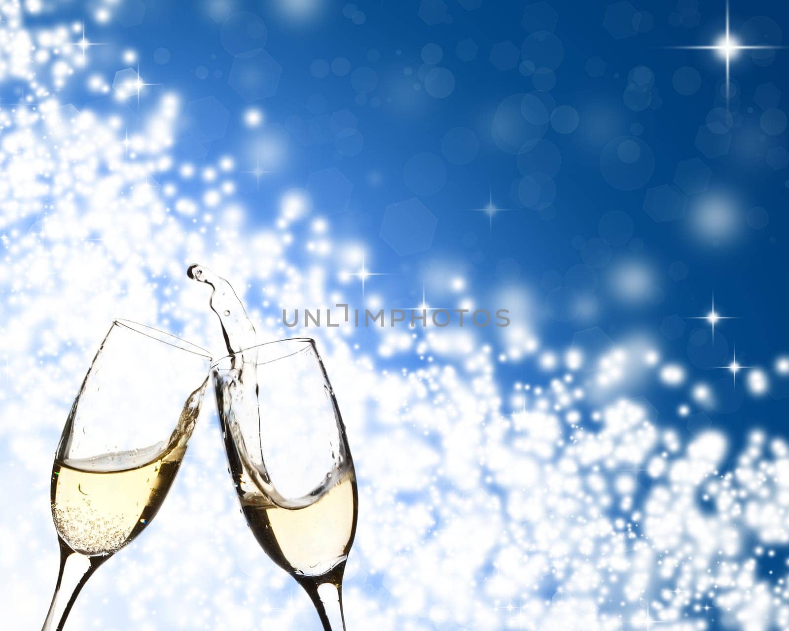 Glasses with champagne against holiday lights