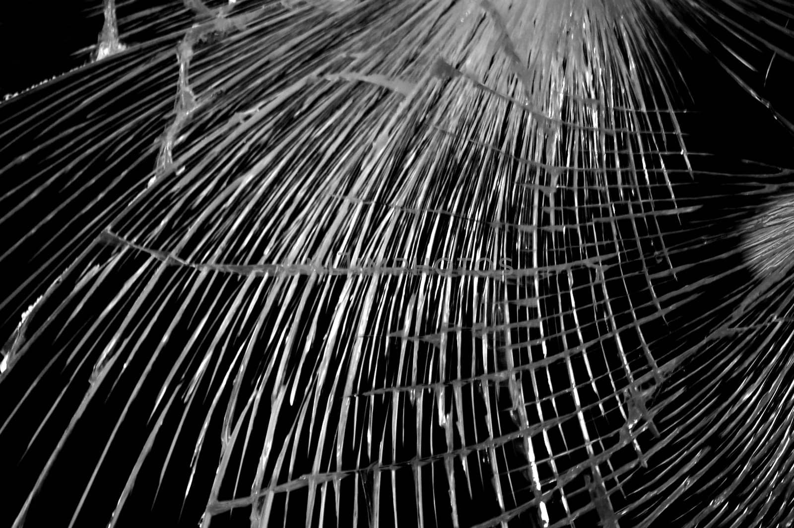 Light abstraction on broken glass background. Black and white.
