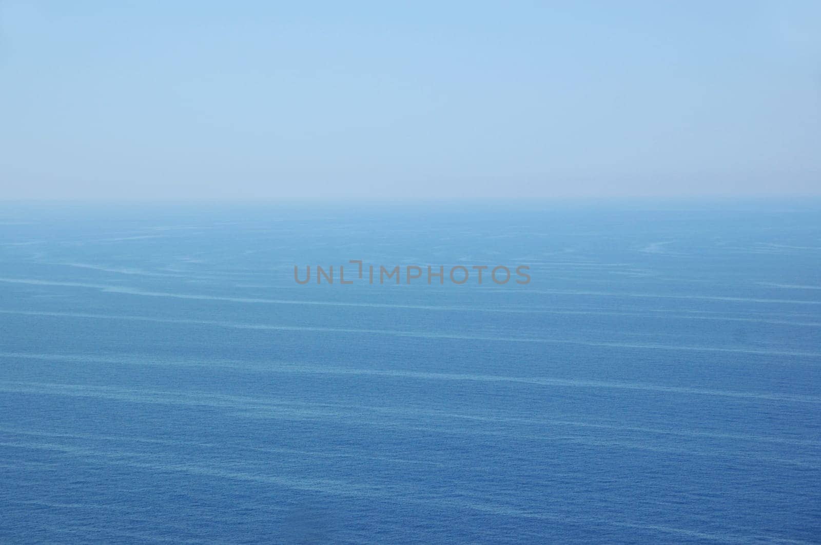 Ocean currents deep sea water and sky horizon. Nature background.