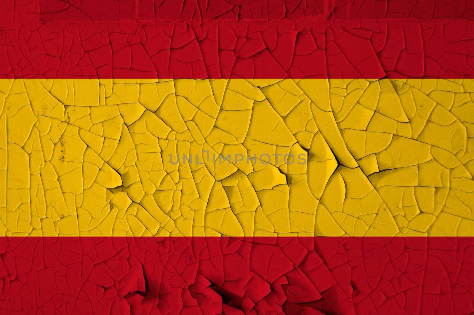 Spanish national flag on peeling paint wall. Weathered grunge background.