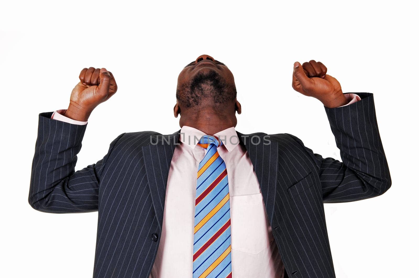 A very happy black business man raising his arms and his head back.for white background..