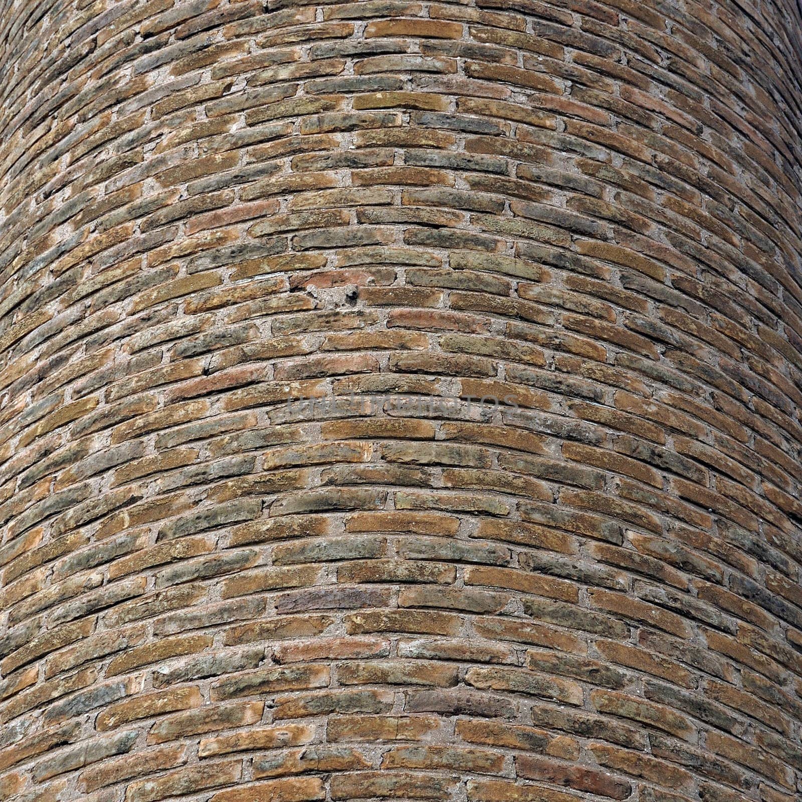 Curved brick wall background texture. Factory chimney detail.