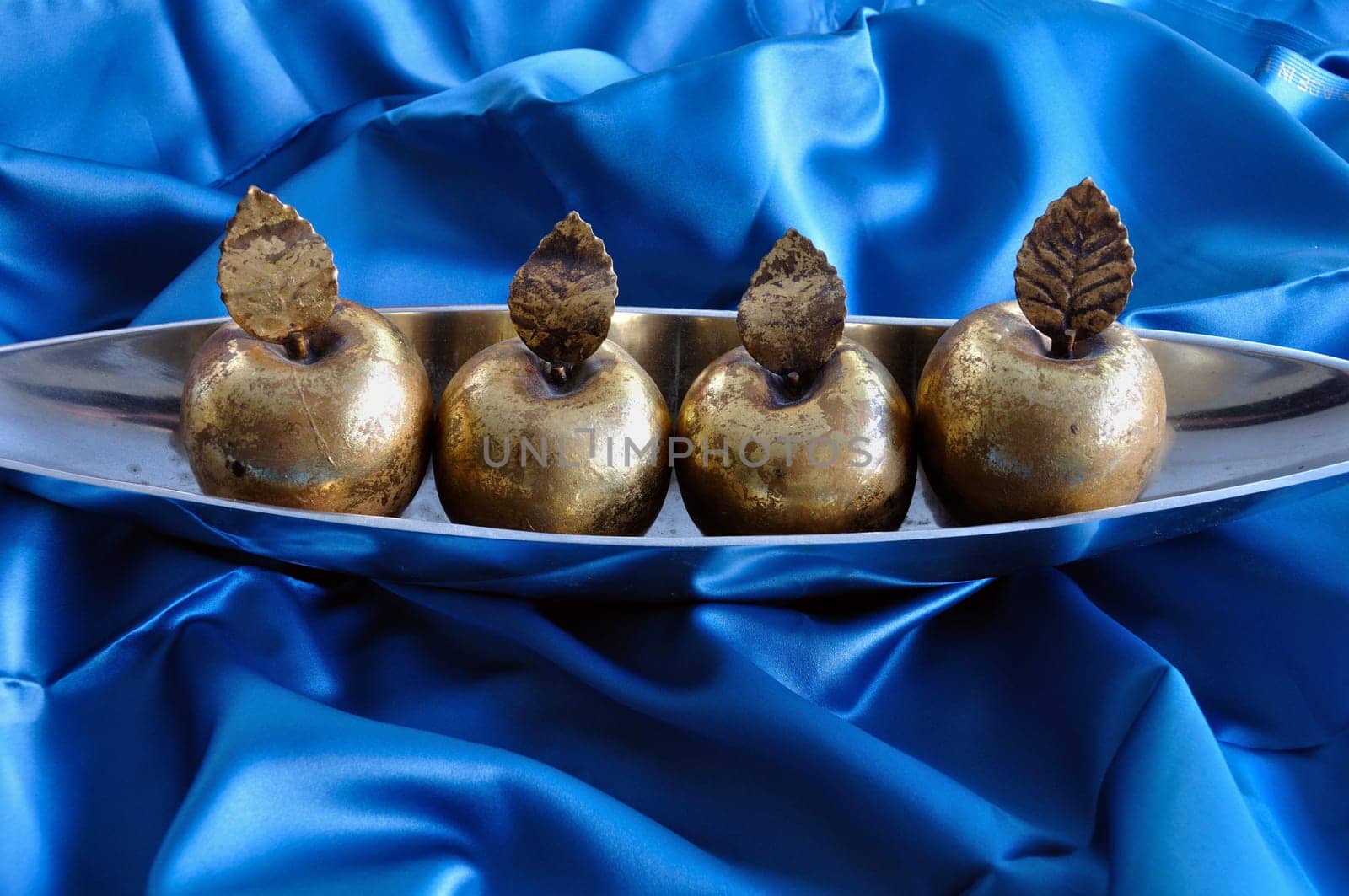 Golden apples on blue background. Christmas symbol vintage decorative objects.
