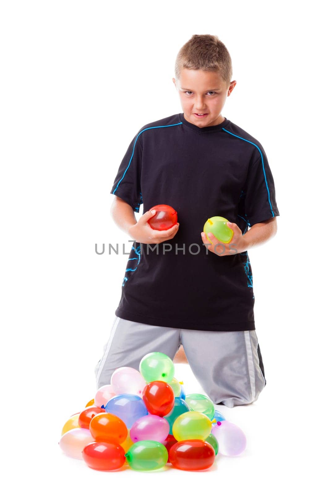 Boy with a pile of water balloons isolated on white background