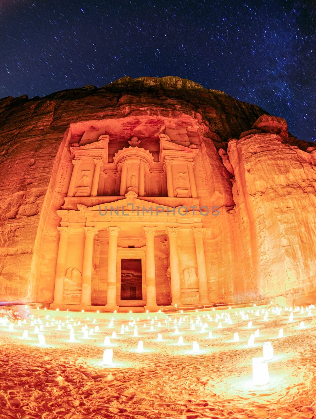 Night show at Petra. Long exposure fisheye image showing Al Khazneh by candlelight and starry sky