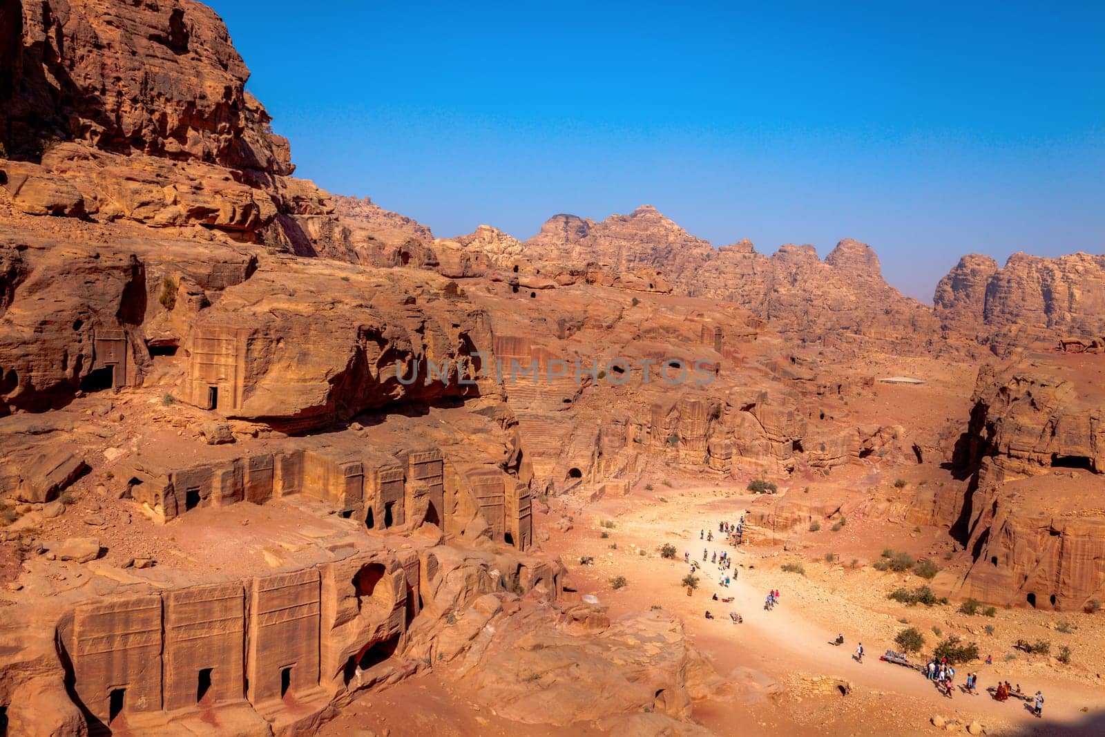 View of desert and ancient tombs carved in the rock in Petra, Jordan