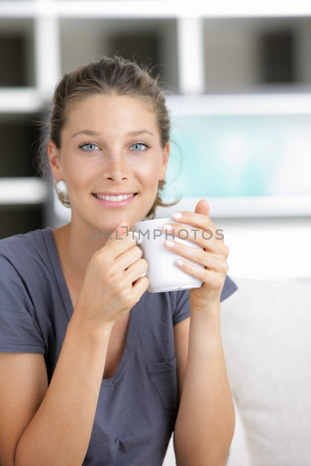 Portrait of a beautiful young lady with cup