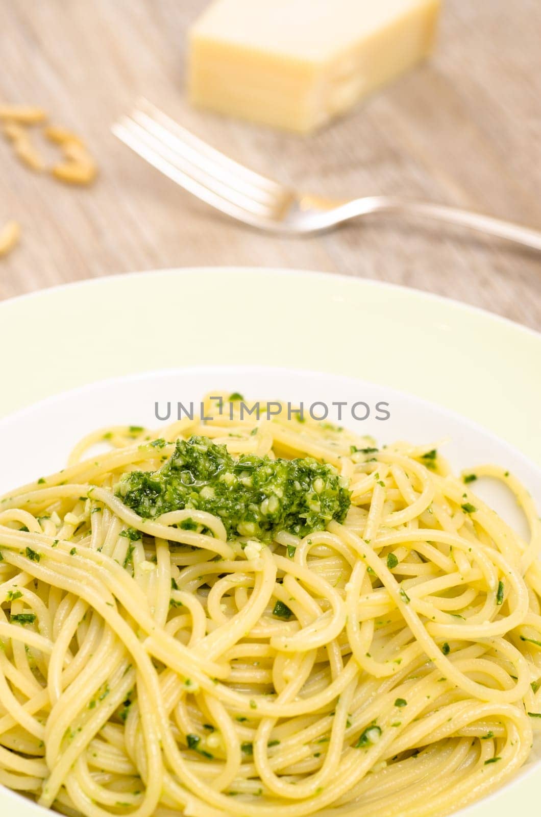 Spaghetti with ruccola pesto and pine nuts and Parmesan cheese