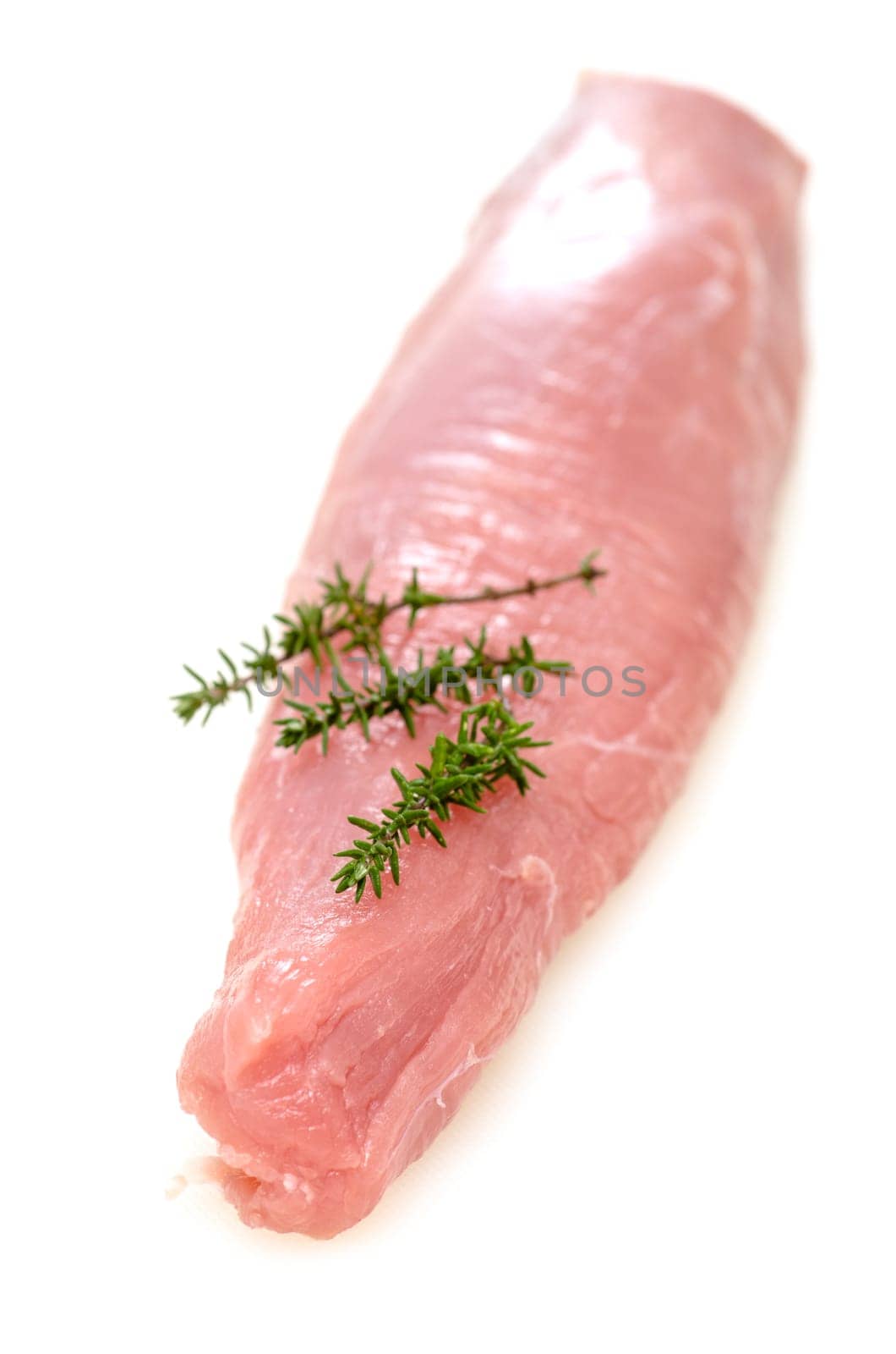 Raw pork tenderloin with thyme in portrait format