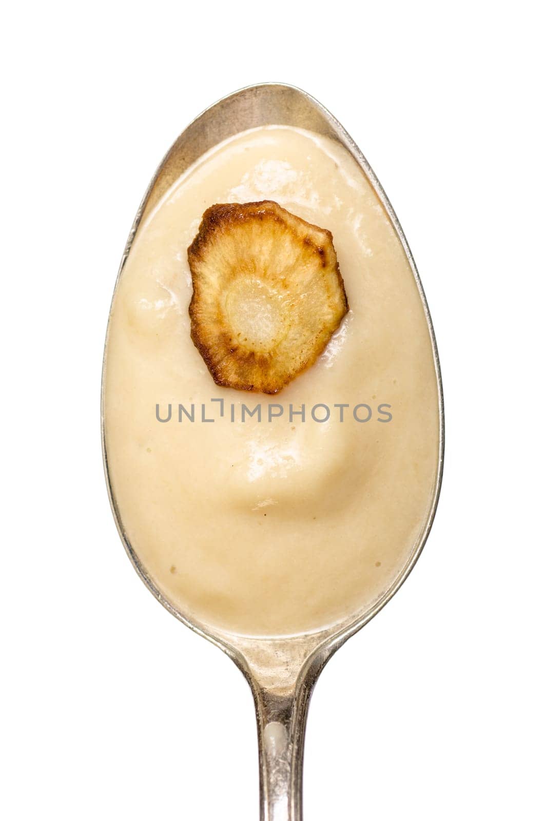 Spoon of parsnip soup and a slice of fried parsnip