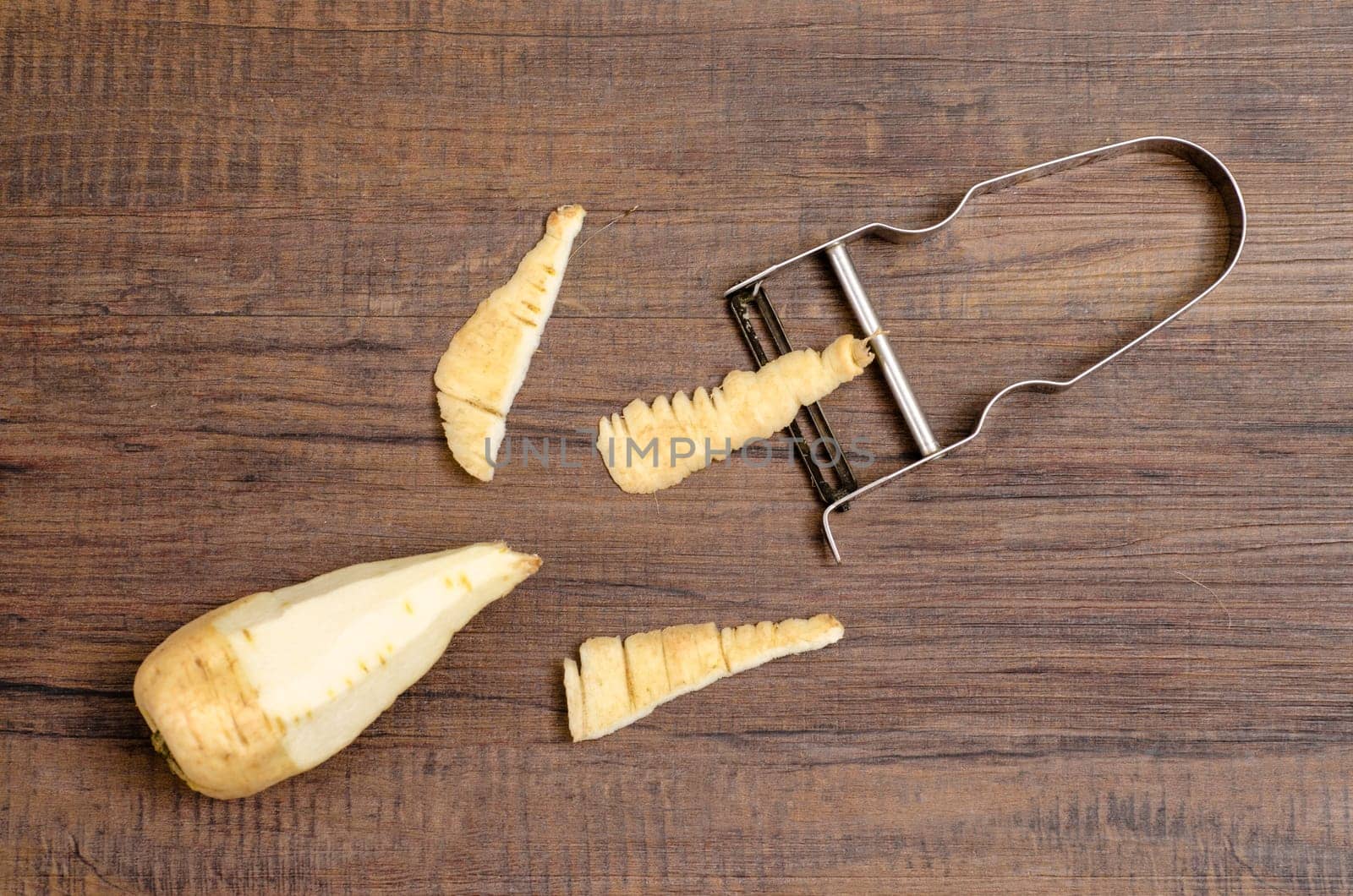 Parsnip and peeler with peeled shell