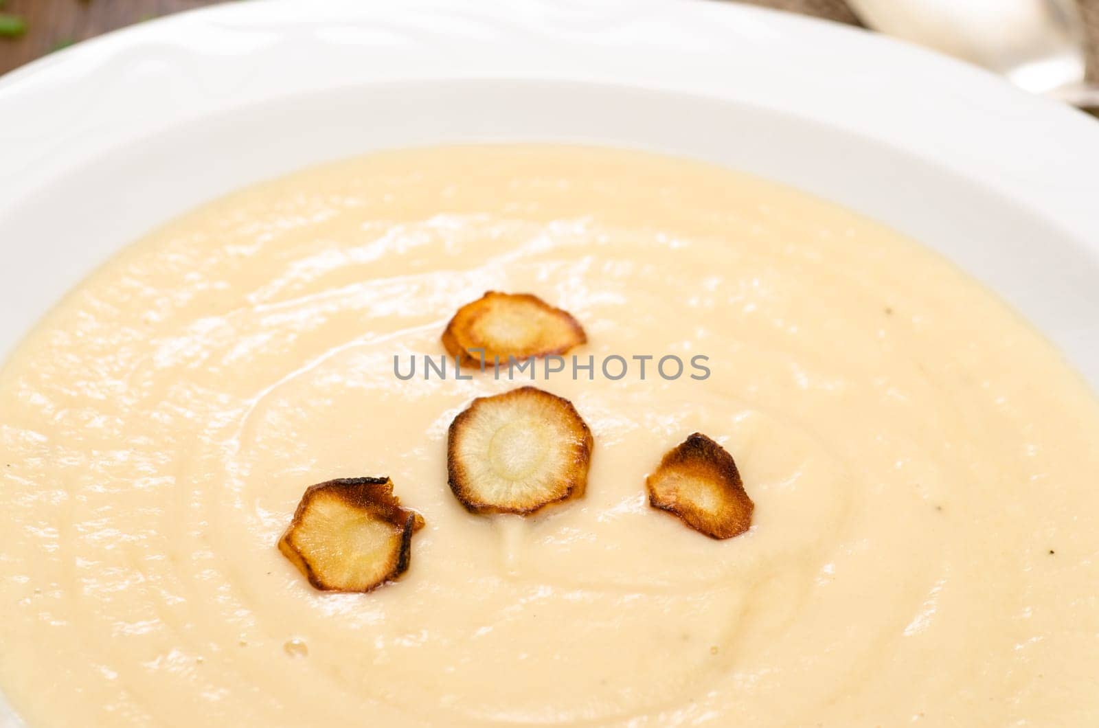 Fried parsnips on a soup in a plate