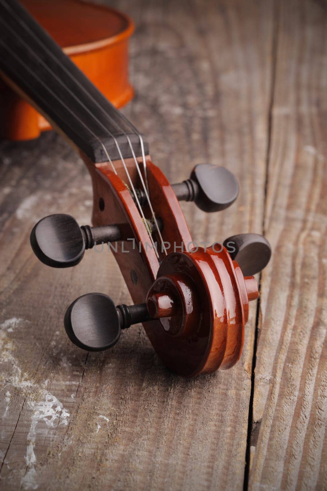 Close up of a violin on old wood background
